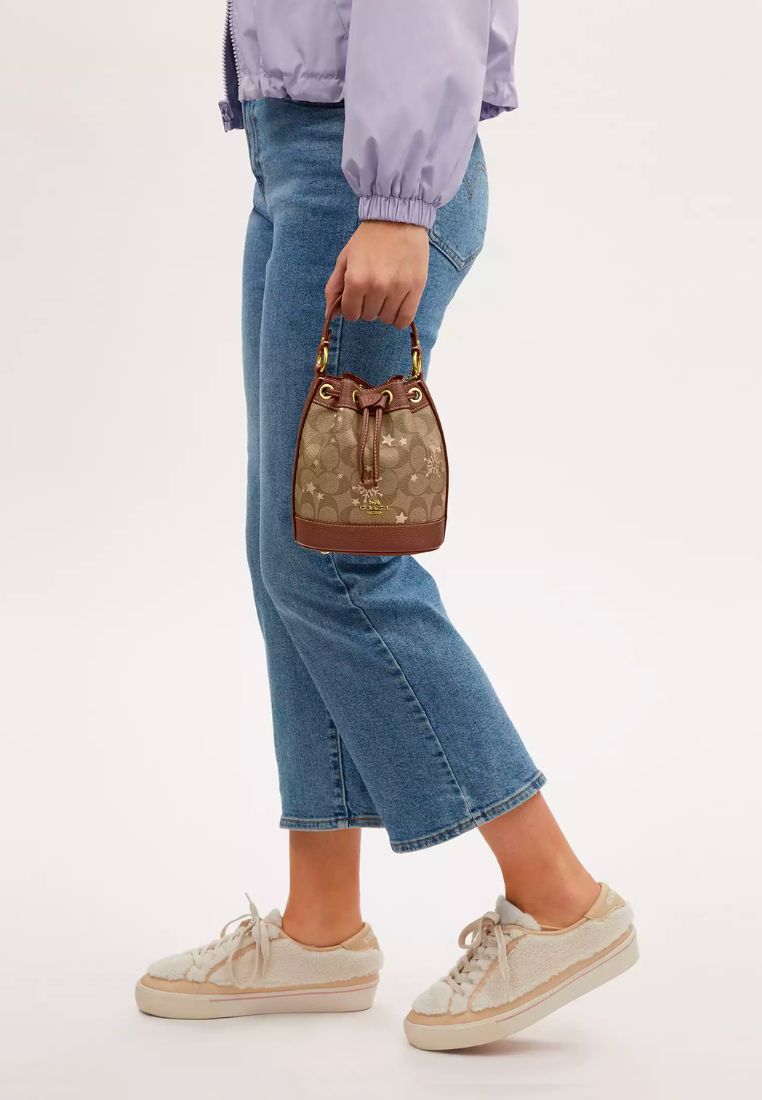 Dempsey Drawstring Bucket Bag 15 In Signature Canvas With Star And Snowflake Print