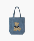 Marithe Francois Girbaud denim coloured canvas tote bag with a teddy bear design in doodle style on a white background